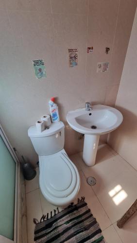 a bathroom with a toilet and a sink at Room in Achada São Filipe, Praia in Praia
