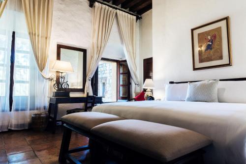 a bedroom with two beds and a window at Quinta Real Oaxaca in Oaxaca City