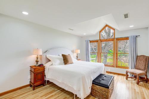 a bedroom with a white bed and a window at Blue Ridge Mountain Condo with Golf Course Views! in Burnsville