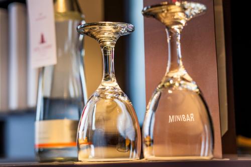 two empty wine bottles sitting on a shelf at Hotel Clement in Prague