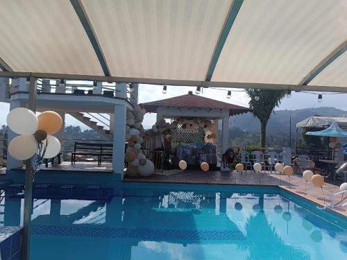 a swimming pool with a gazebo and a party at Finca con Piscina Privada/Jacuzzi/Asador in San Vicente