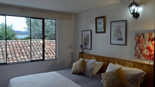 a bedroom with a bed and a large window at Hotel Gran Boutique Sabana in Chía