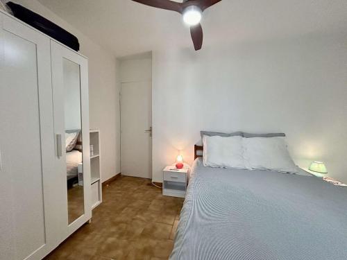 une chambre avec un lit et un ventilateur de plafond dans l'établissement Sainte-Maxime Appt 2 pièces, centre-ville, 4 pers, proche plage - FR-1-226-543, à Sainte-Maxime