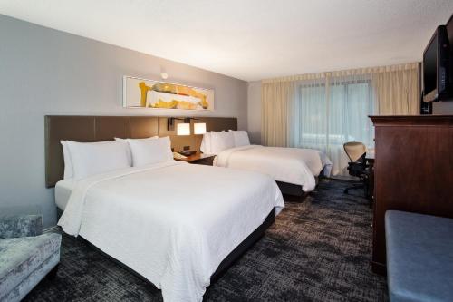 a hotel room with two beds and a desk at Crowne Plaza Chicago-Northbrook, an IHG Hotel in Northbrook