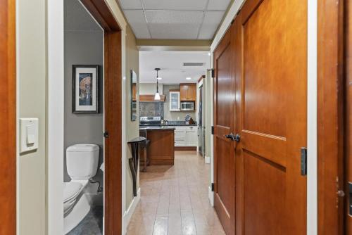 a hallway leading to a kitchen with a toilet at Luxury Resort 2BR/2Bath Sleeps 6 in Canmore