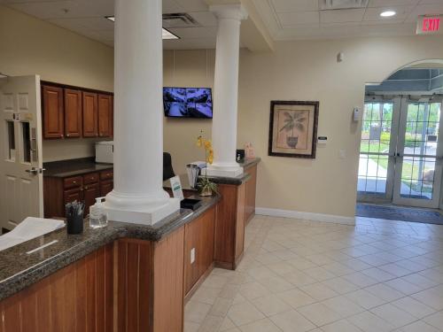 an office lobby with a counter and columns at Lakeview Condo Hotel near Disney in Orlando