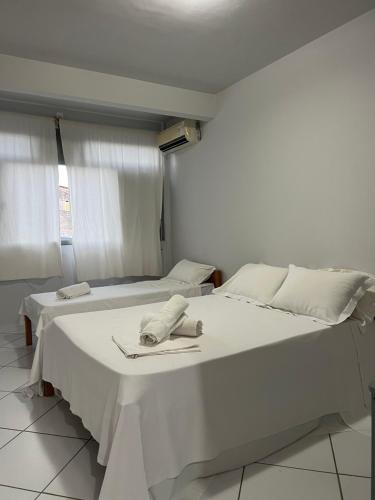 a white bed with a napkin on top of it at Pousada da Barra Prado Bahia in Prado