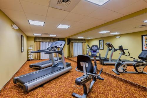 a gym with several treadmills and elliptical machines at Holiday Inn Express Hotel & Suites Salina by IHG in Salina