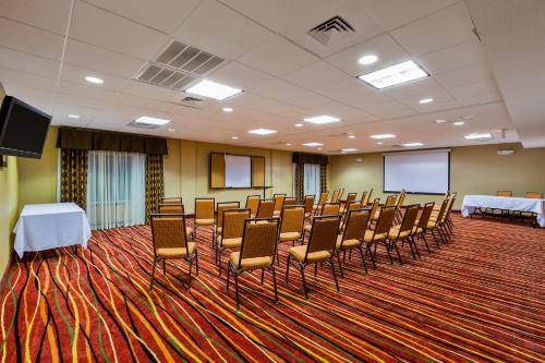 a conference room with chairs and tables and screens at Holiday Inn Express Hotel & Suites Salina by IHG in Salina