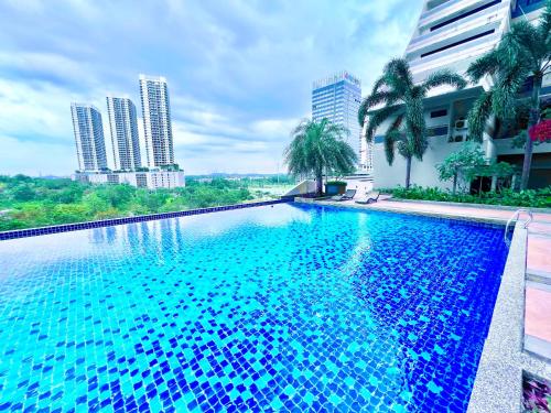 a swimming pool in the middle of a city with tall buildings at Legoland -8min Walk-Spacious Kids friendly -500MBS-1-12Pax Kairos Stay in Nusajaya