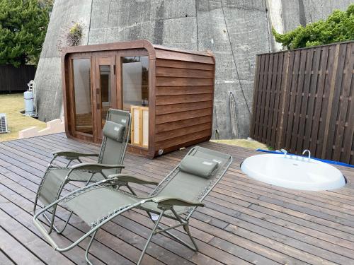 a couple of chairs and a sink on a deck at Cam Cam Dome House & SAUNA 豊岡海岸 in Minamiboso