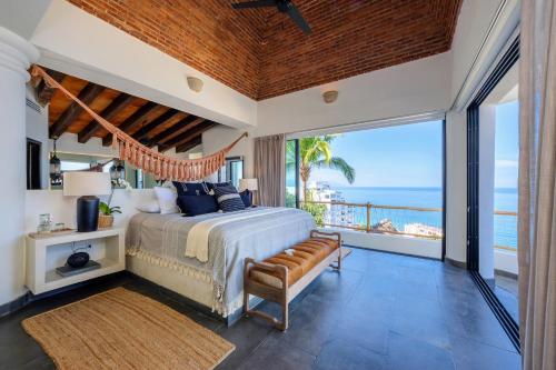 a bedroom with a bed and a view of the ocean at NEW - Amapas Luxury 5-Bedroom Villa in Puerto Vallarta