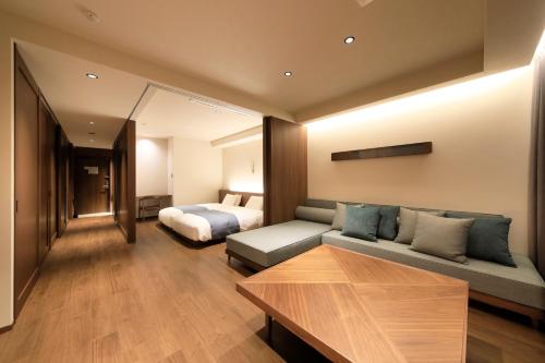 a living room with a couch and a bed at BLISSTIA Hakone Sengokuhara in Hakone