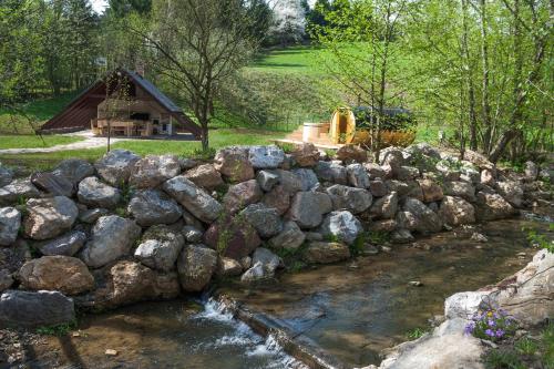 a rock retaining wall next to a stream at Chalet Hovel in Mănăstirea Humorului