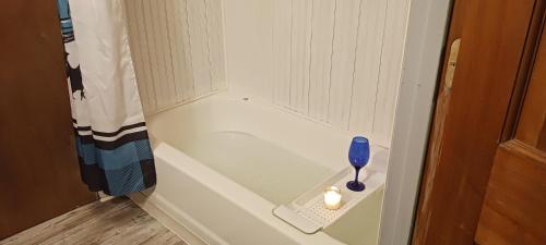 a small bathroom with a spoon and a candle at The Little Cabin on Huckleberry in Rural Retreat