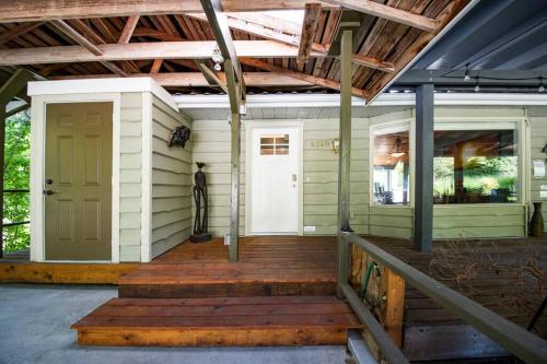 a front porch of a house with a door and stairs at Family, Pet Friendly Sechelt Waterfront Home, Beach Access, Sleeps 14 in Sechelt