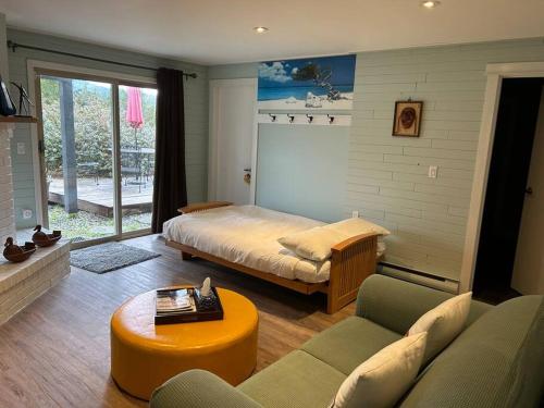 a living room with a bed and a couch at Family, Pet Friendly Sechelt Waterfront Home, Beach Access, Sleeps 14 in Sechelt