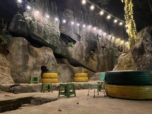 a room with chairs and lights on a rock wall at Thành Đạt Hostel ( Hostel and Motobike Rental ) in Bản Tùy