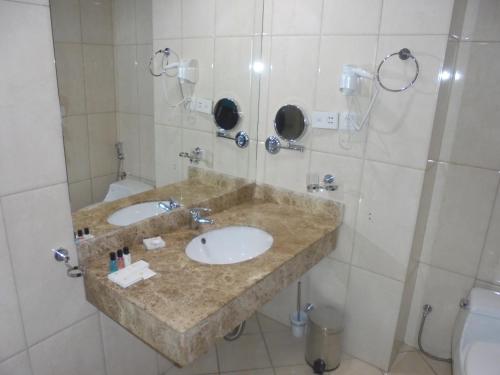 a bathroom with two sinks and a toilet at Saro Maria Hotel in Addis Ababa