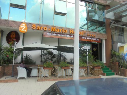 a man sitting at a table outside of a restaurant at Saro Maria Hotel in Addis Ababa