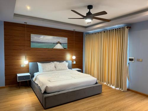 a bedroom with a bed and a ceiling fan at One Beach Resort By EHM in Koh Rong Sanloem
