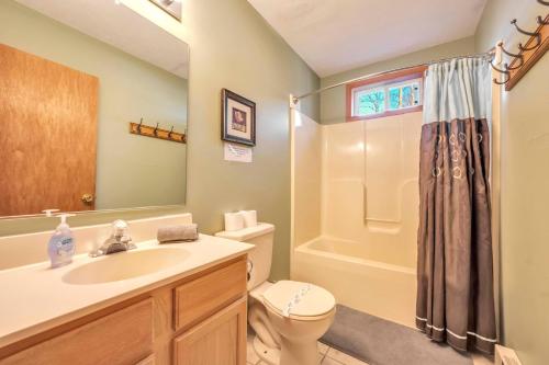 a bathroom with a sink and a toilet and a shower at Pocono Pinnacle by AvantStay Steps to the Lake Game Room Large Deck in Albrightsville