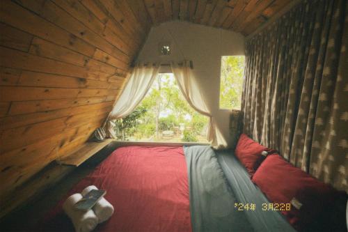 a bed in a room with a window at Nấp Đà Lạt in Da Lat