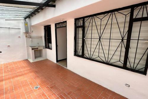 an empty room with large windows and a brick floor at Amplio e impecable apartamento en Cajicá in Cajicá