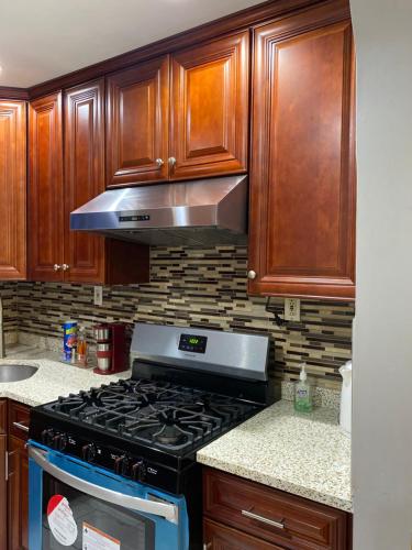 a kitchen with a stove and wooden cabinets at Haus Serenity in Hollis