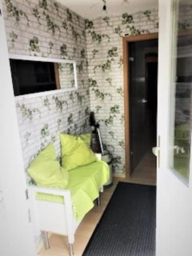a room with a chair with yellow pillows at Ferienwohnung Edith in Güster