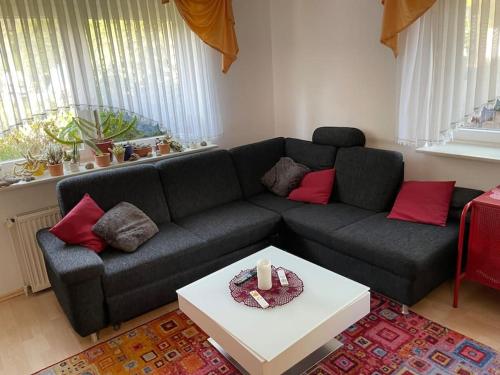 a living room with a black couch and a table at Ferienwohnung Edith in Güster