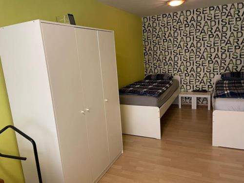 a room with a bedroom with a bed and a wall at Ferienwohnung Edith in Güster