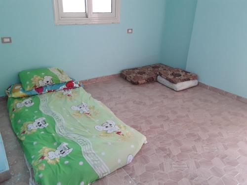 a bedroom with a bed with mickey mouse sheets at غرفه بشقه بأطلاله على البحر in ‘Izbat al Qaşr