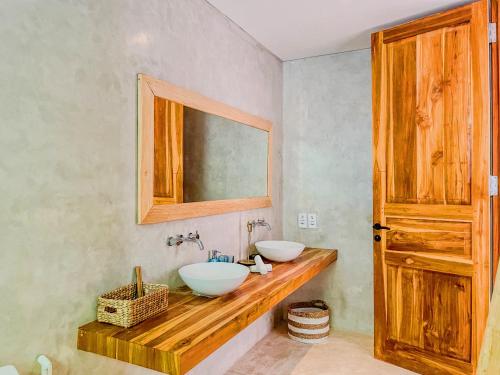 a bathroom with two sinks and a mirror at Marlaca Villas Lombok in Kuta Lombok