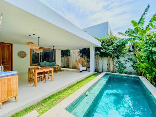 a villa with a swimming pool and a house at Marlaca Villas Lombok in Kuta Lombok
