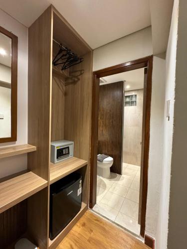 a bathroom with a toilet and a shower in a room at Sukajadi Hotel, Convention and Gallery in Bandung