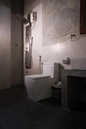 a bathroom with a shower and a toilet and a sink at Rise & Set Arugam bay in Arugam Bay