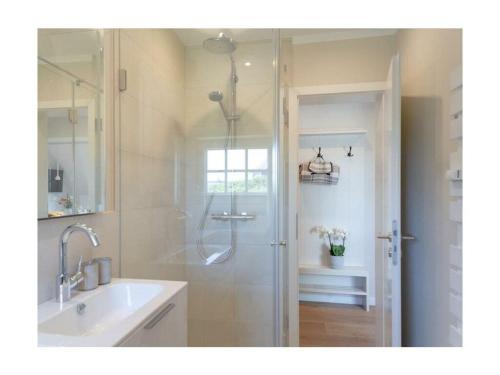 a bathroom with a shower and a sink at Rüm Hart II apartment 12 in Hörnum