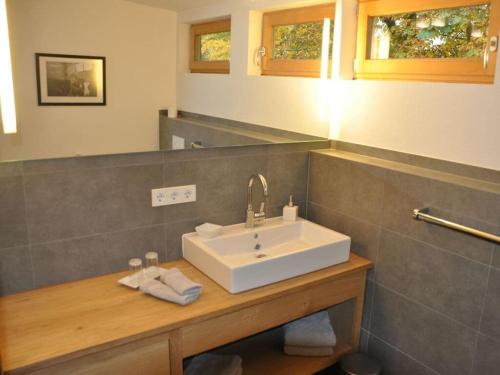 a bathroom with a sink and a mirror at Suite Nuss Modern retreat in Bad Wiessee