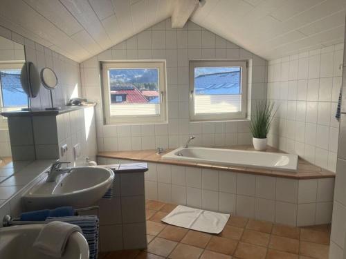 a bathroom with a tub and a sink at 1 Porzig Modern retreat in Fischen