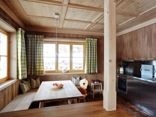 a living room with a table and a kitchen at Suite Linde Modern retreat in Bad Wiessee