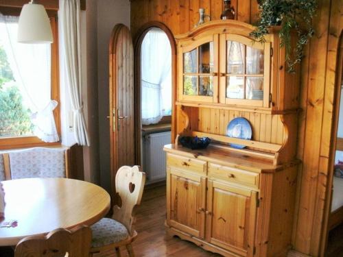 a dining room with a wooden hutch and a table at Bärenhüsli No 7 in Titisee