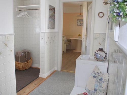 a room with a hallway with a sink and a room with a room at Haus Hoppel - FeWo ground floor in Rantum
