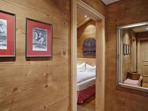 a bedroom with a bed in a room with wooden walls at Suite Birch Modern retreat in Bad Wiessee