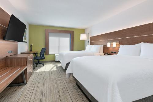 a hotel room with two beds and a flat screen tv at Holiday Inn Express - San Antonio East I-10 , an IHG Hotel in San Antonio