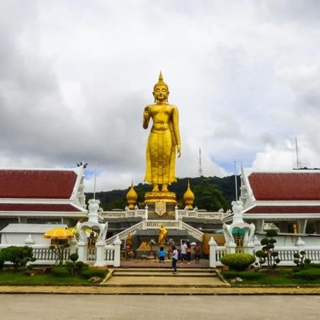 a large golden statue in front of a building at LAIWAII HOME in Hat Yai