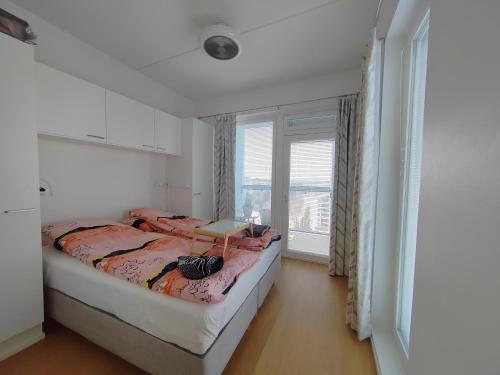 a bedroom with a bed and a large window at Casa di Sanna with Sauna & free parking in Vantaa