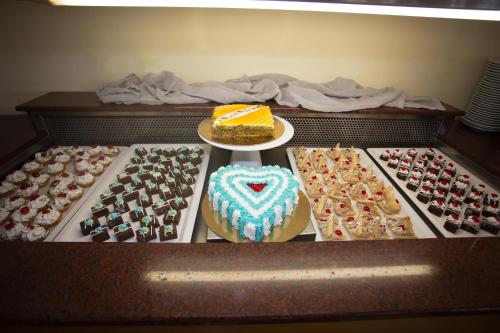 a drawer filled with different types of cakes and pastries at Eurovillage Achilleas Hotel in Mastichari