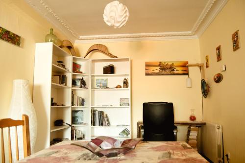 a room with a bed and a desk and shelves at Zuhaitz in Azpeitia