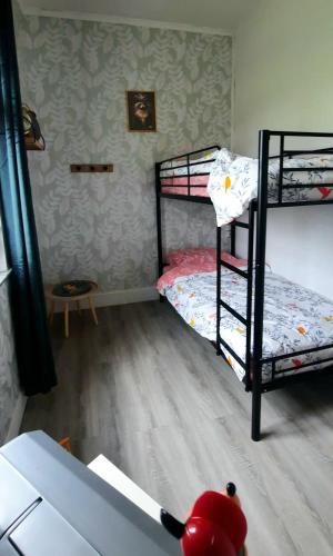 a room with two bunk beds and a table at La Villa Beausejour in Baives